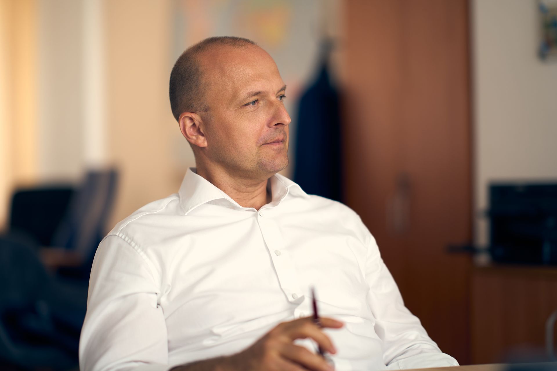 Professional portrait of a thoughtful businessman in an office setting in Bratislava, Slovakia.