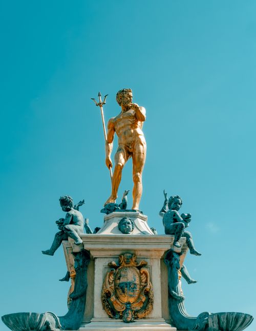 Free Dramatic statue of Poseidon with cherubs in Batumi, Georgia, set against a vibrant turquoise sky. Stock Photo