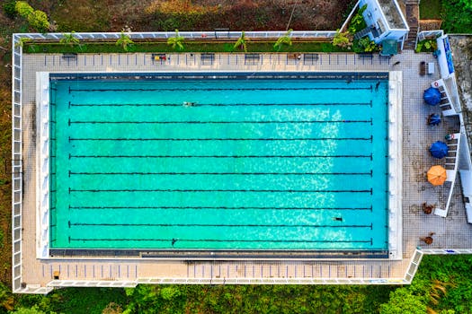 Drone shot of a vibrant swimming pool in Jawa Barat, Indonesia, showing clear turquoise water.