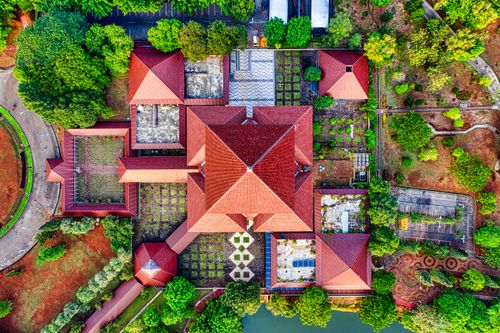 Free Stunning aerial shot of traditional red-roofed architecture in lush greenery of Jawa Barat, Indonesia. Stock Photo