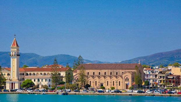 A captivating view of Agios Dionysios Church by the waterfront in Zakynthos, Greece.
