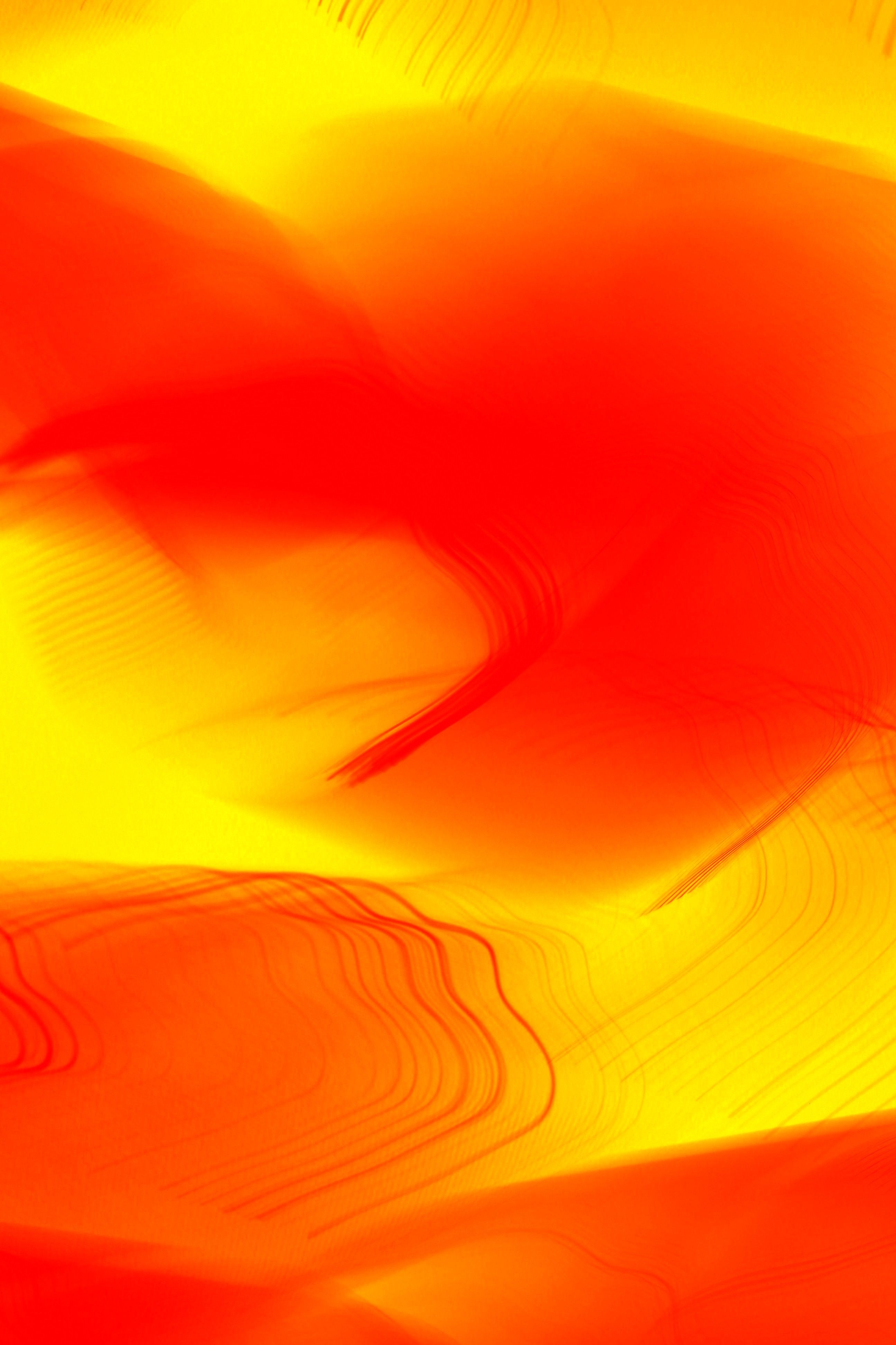 Abstract art featuring vivid red and yellow tones creating a dynamic visual flow.