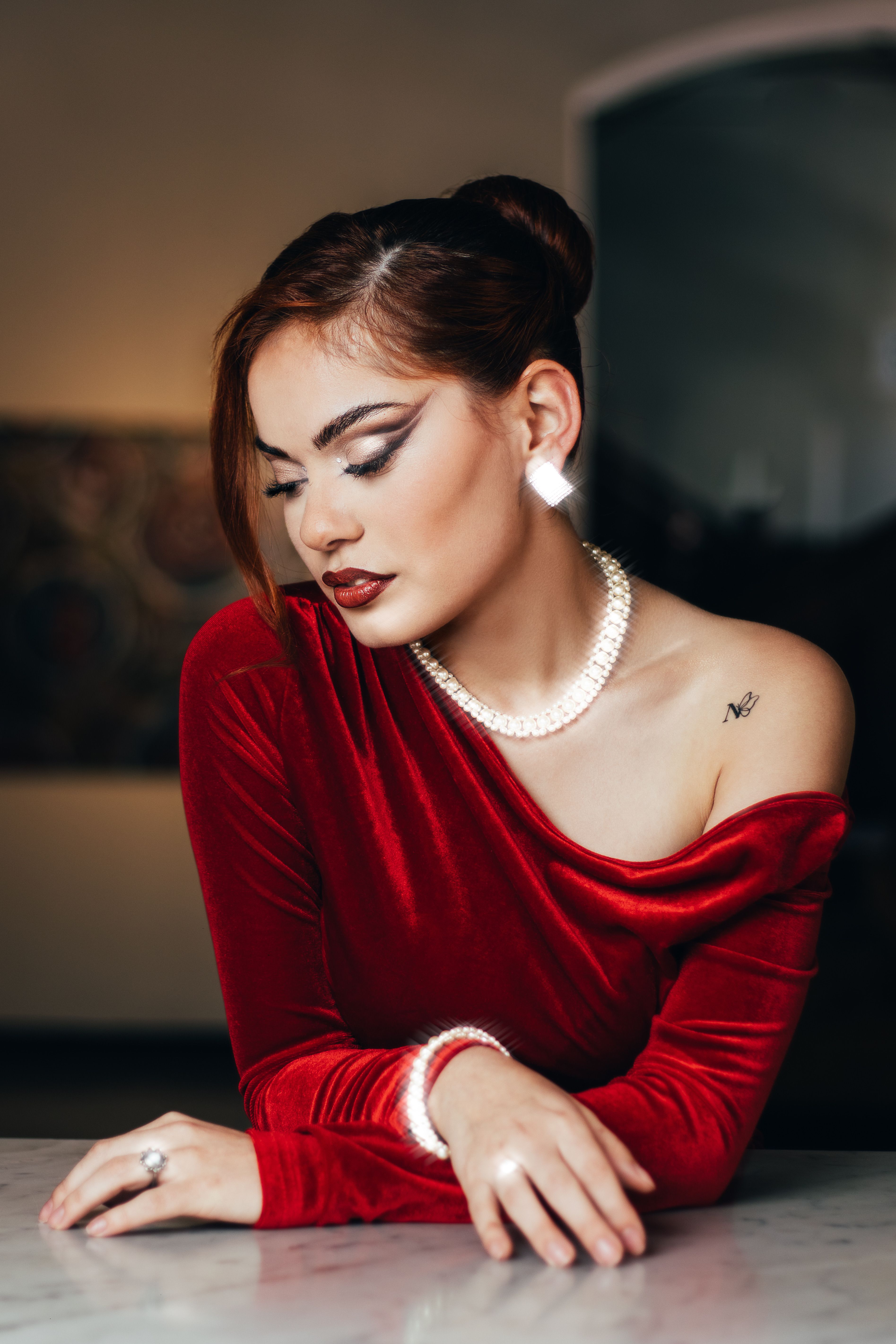 Elegant Woman in Red Velvet Dress with Pearl Jewelry · Free Stock Photo
