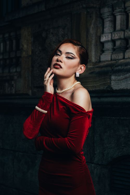 Woman in a red velvet midi dress for date night