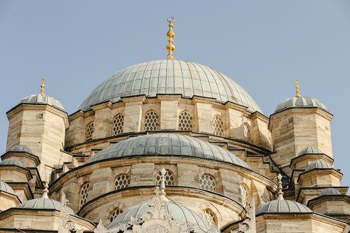Free Explore the intricate design and architectural beauty of a historic mosque dome against a clear sky. Stock Photo