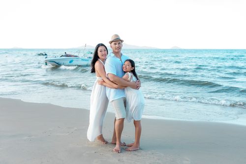 Free Happy family bonding on the beach in Hội An, enjoying the summer sun and sea. Stock Photo