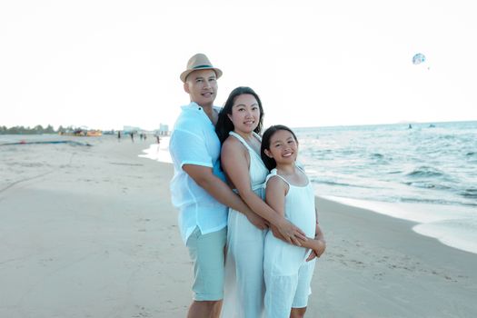 Family enjoying a warm sunset on the picturesque beach in Hoi An, Vietnam. Perfect summer moment.