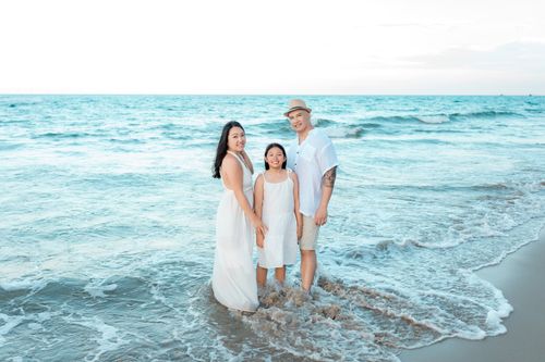 Free Family enjoying a day on the beach in Hội An, Vietnam. Perfect for lifestyle and travel themes. Stock Photo