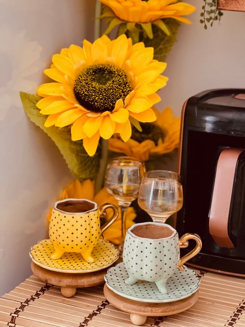 Free Bright sunflower and polka dot coffee cups create a cozy kitchen vibe. Stock Photo