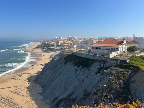 Free Stunning view of Praia das Maçãs beach and cliffs in Colares, Portugal under a clear blue sky. Stock Photo