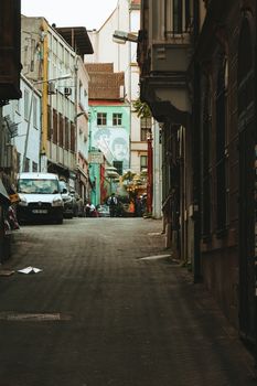 Explore a picturesque narrow street in Istanbul adorned with vibrant graffiti.
