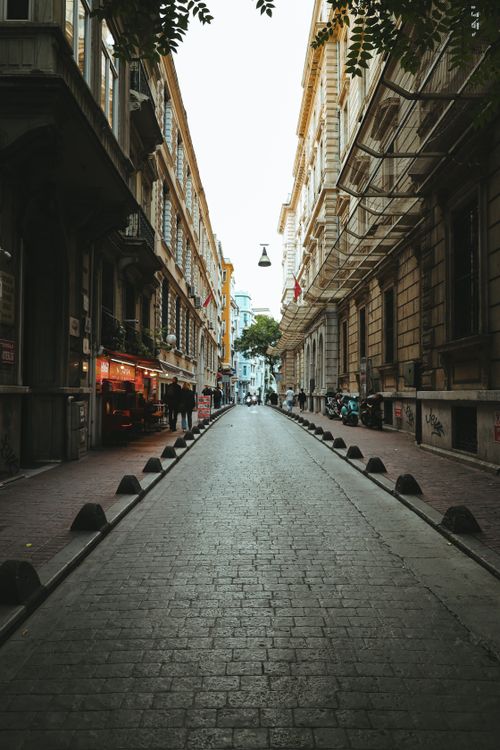 Free Explore a narrow street in Istanbul featuring historic architecture and a lively atmosphere. Stock Photo