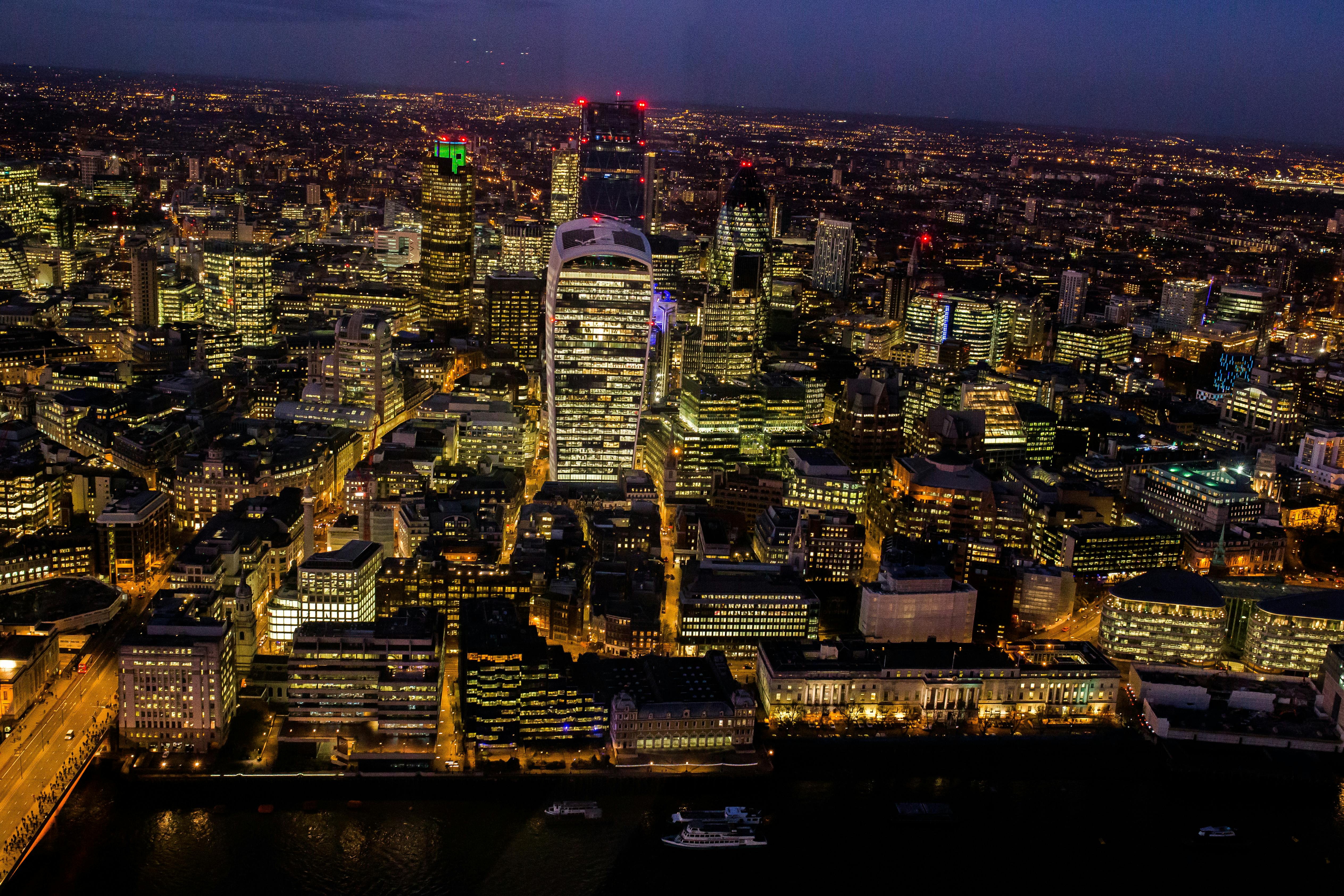 A stunning aerial view capturing London's illuminated skyline at night.