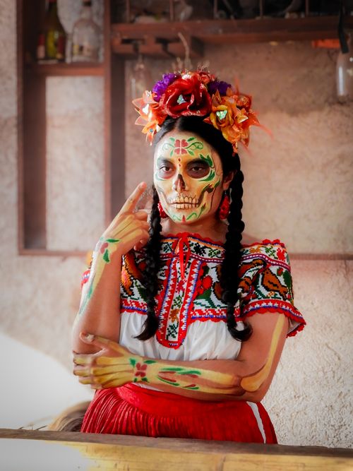 Free Cultural Day of the Dead celebration portrait featuring colorful Catrina makeup and traditional attire. Stock Photo