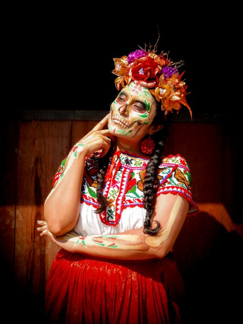 Free A colorful portrait of a person wearing Catrina makeup and traditional attire for Día de Muertos in Mexico City. Stock Photo