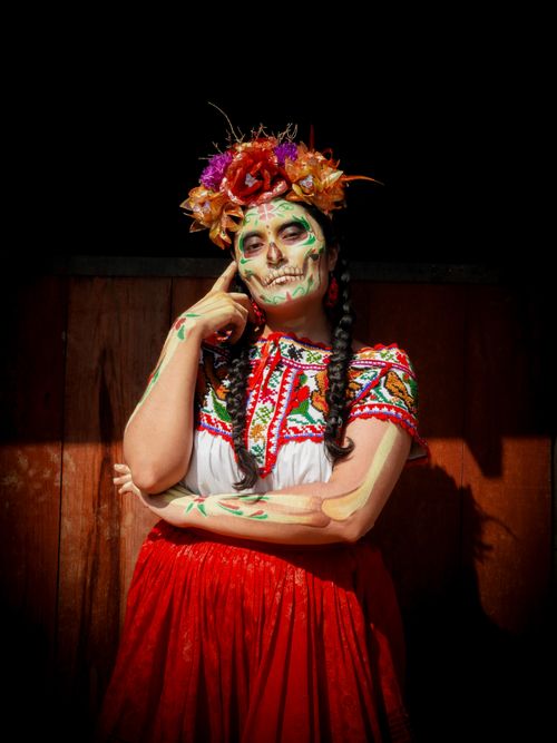 Free Colorful Day of the Dead costume with traditional makeup and floral headpiece in Mexico. Stock Photo