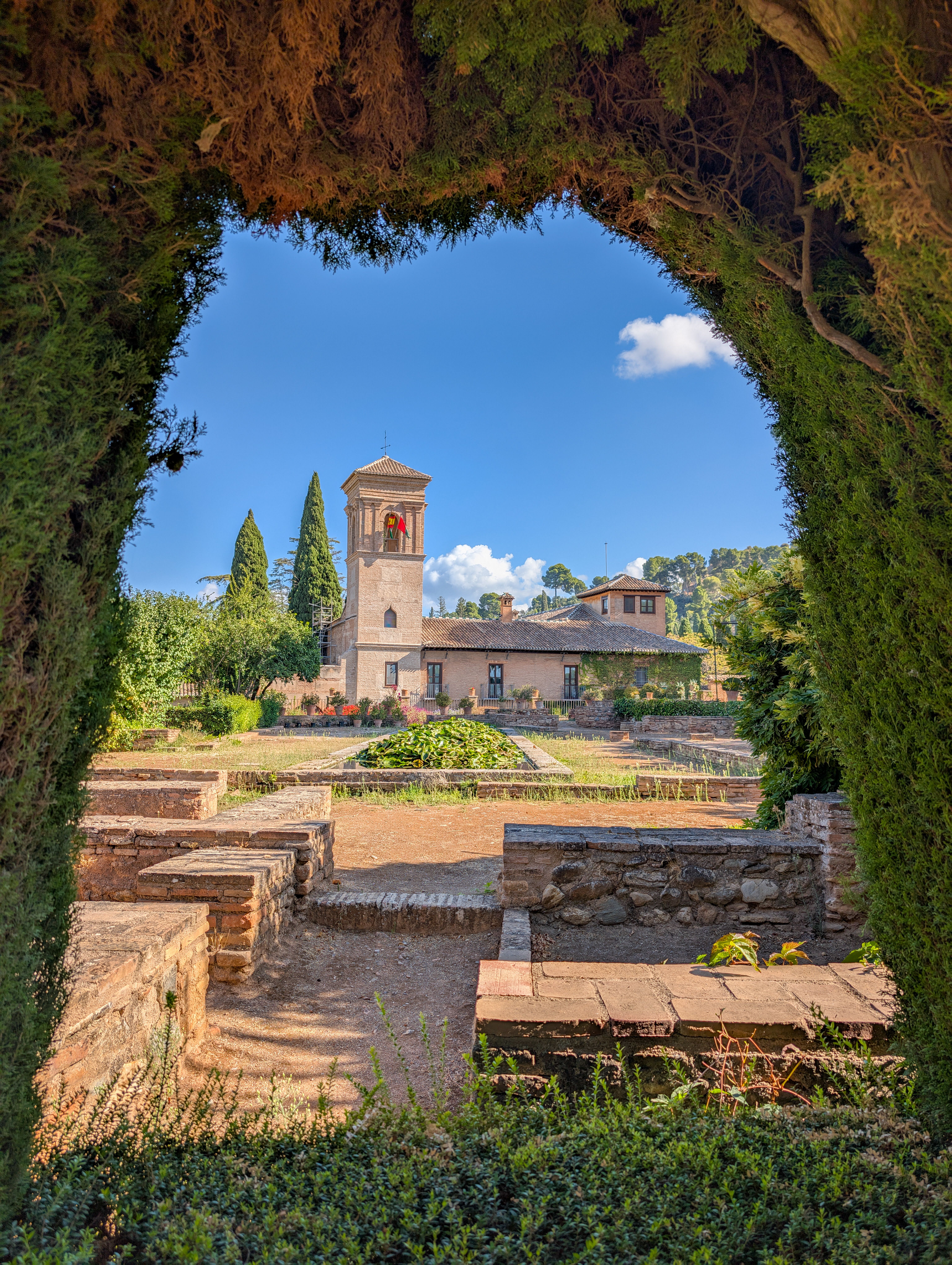Scenic view of the Alhambra Gardens and medieval architecture in Granada, Spain.