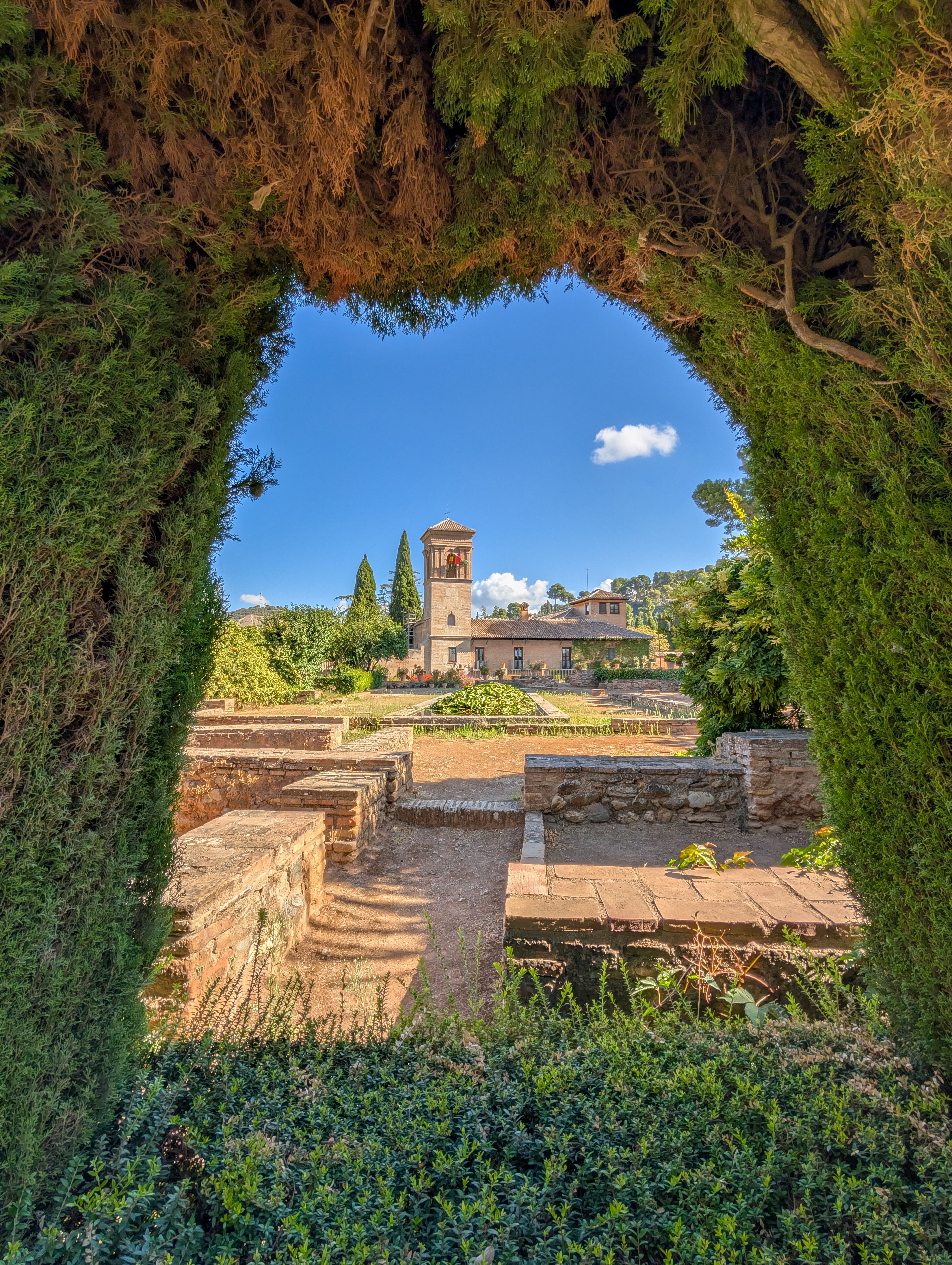 Explore Granada's Alhambra gardens with stunning Islamic architecture and lush greenery.