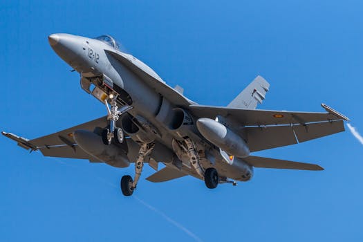 An F/A-18 fighter jet soaring in the clear sky, showcasing aerial prowess and modern aviation technology.
