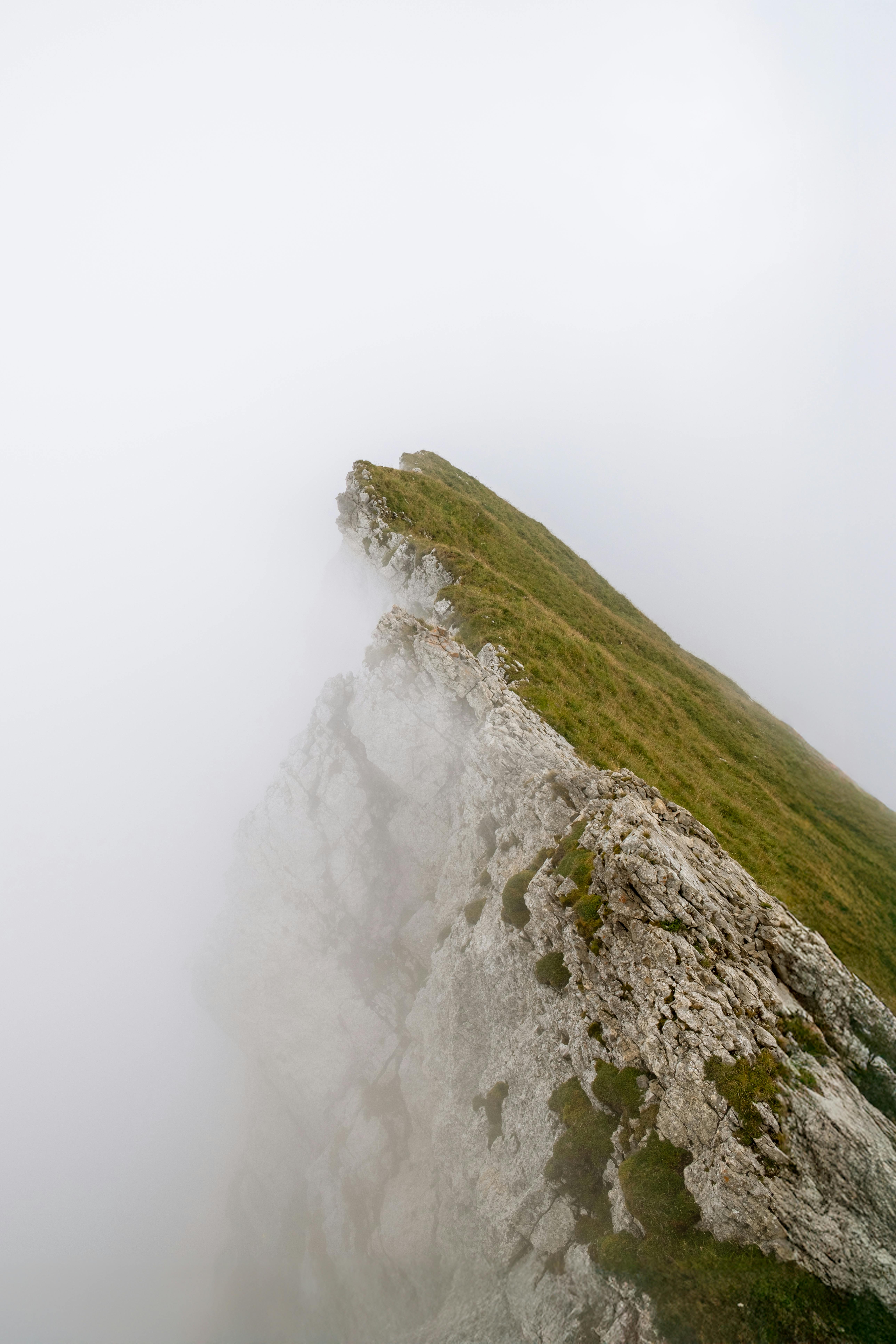 Dramatic view of a cliff shrouded in fog near Hergiswil, Nidwalden, Switzerland.