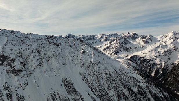 A breathtaking view of the snow-covered Swiss Alps in Graubünden during winter.