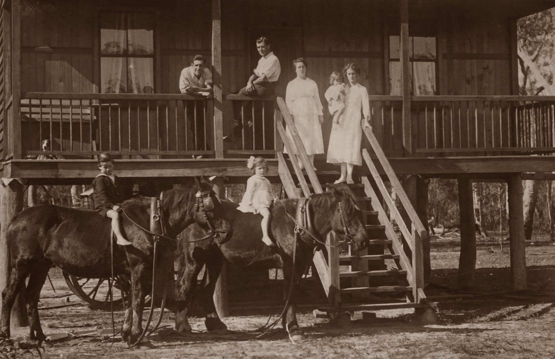 Vintage Australian family outside a wooden house