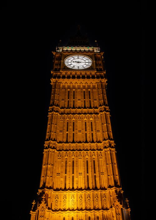 Free Gothic architecture of Big Ben glowing against the night sky, London landmark. Stock Photo