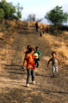 Children enjoying playtime on a rural path in Ankara, Türkiye, capturing joyful childhood moments.