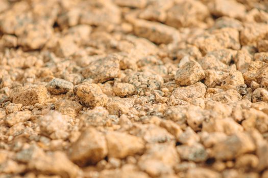 Macro shot of textured rocks with a warm color tone, highlighting natural detail.