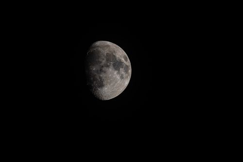 Free A detailed night photograph of Earth's moon showcasing its craters and surface texture. Stock Photo
