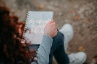 Woman Sitting and Holding Book