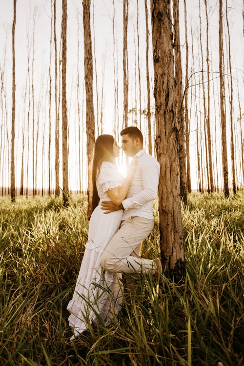 Man and Woman Standing Beside Tree