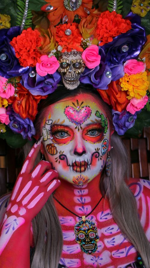 Free Colorful Day of the Dead face paint with floral crown and skull decorations, celebrating cultural traditions. Stock Photo