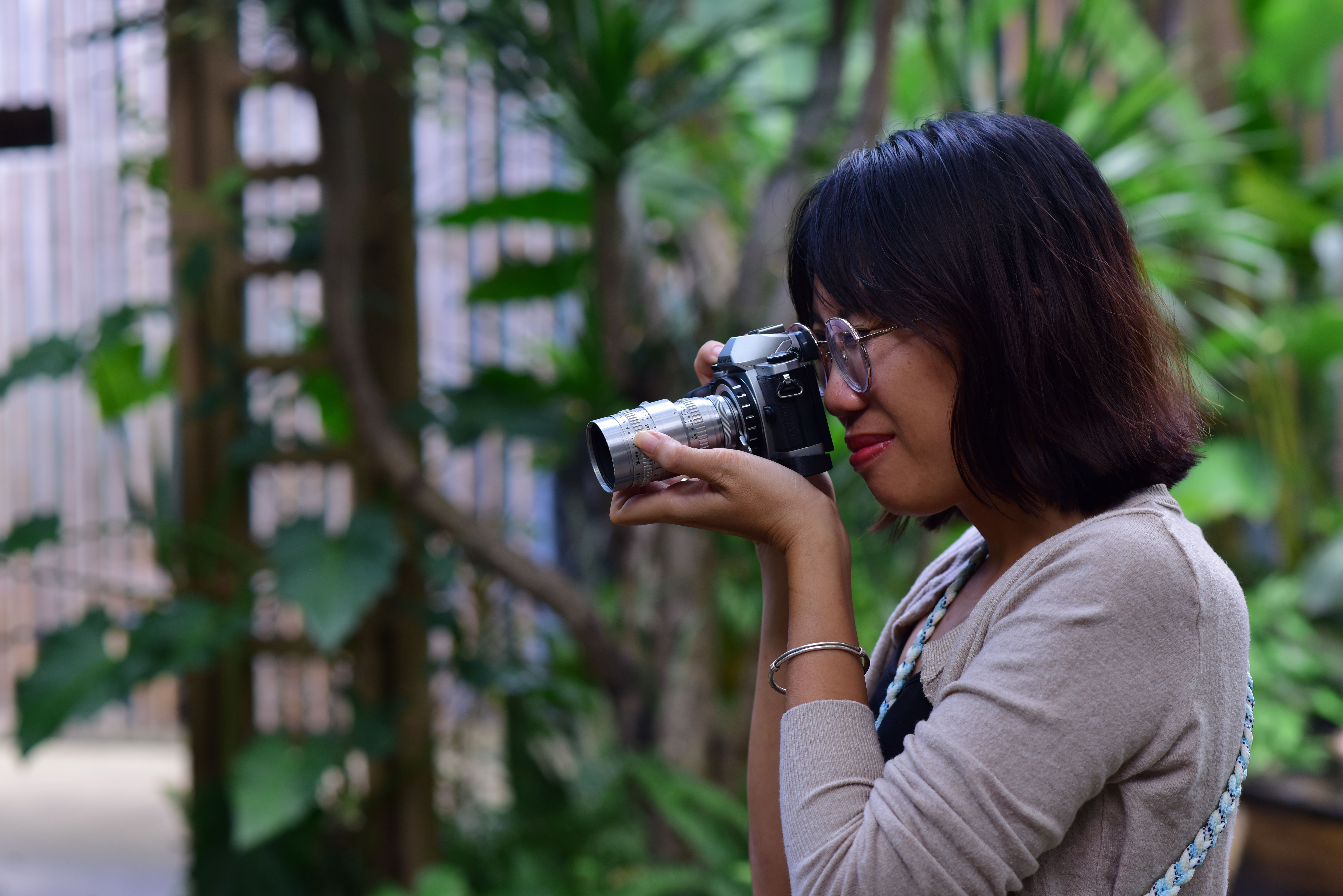 Woman Photographer Outdoors Shooting with DSLR · Free Stock Photo