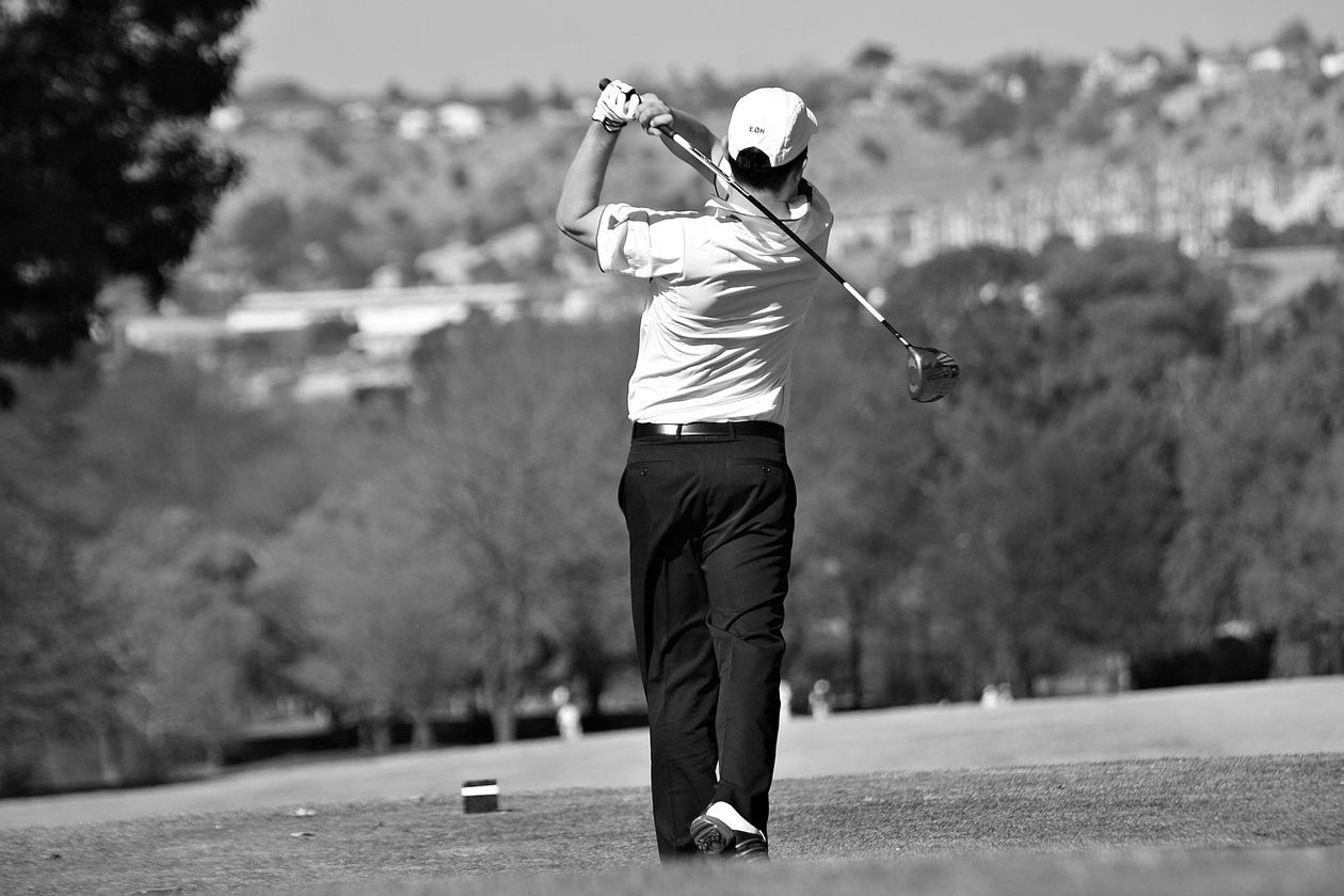 Golfer swinging a golf club on the course