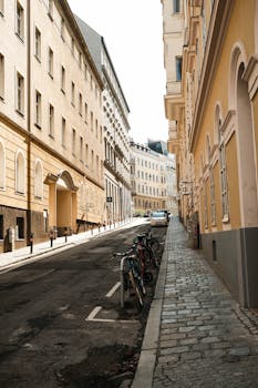 Sunny street scene in Vienna showing historical architecture and bicycles parked along the sidewalk.