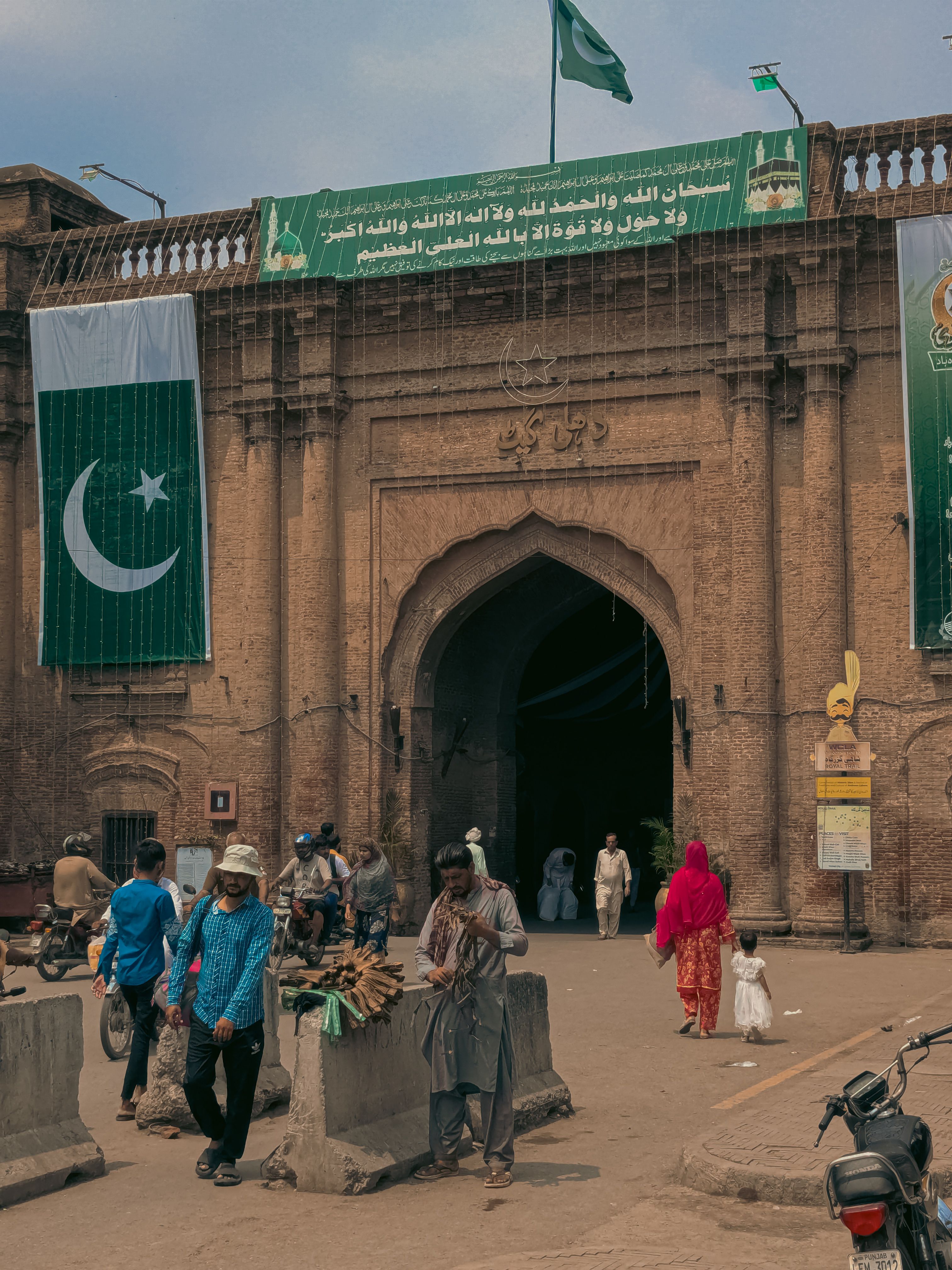 Lahore Fort Entrance with National Flags and Visitors · Free Stock Photo