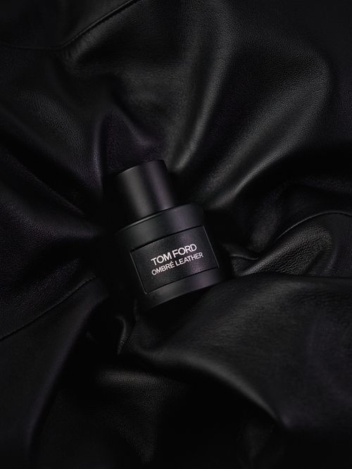 Free Sophisticated black Tom Ford Ombré Leather fragrance bottle on luxury leather fabric. Stock Photo