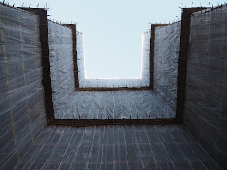 Looking up at a high-rise construction site in Hong Kong, showcasing architectural progress.