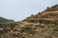 Rugged volcanic landscape on a hillside in La Gomera, showcasing natural geological formations and arid wilderness.