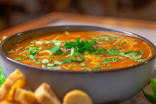 Close-up of a vibrant, aromatic curry garnished with fresh herbs, perfect for food lovers.