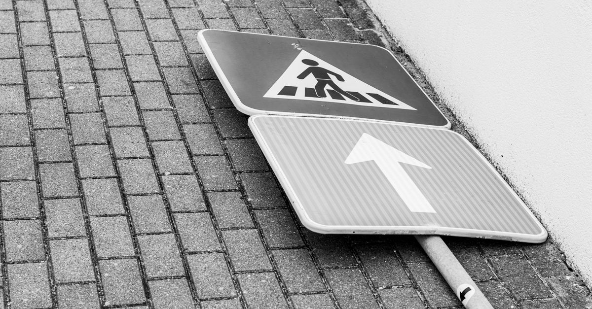 Fallen Sign Fallen Street Sign on Brick Pavement · Free Stock Photo