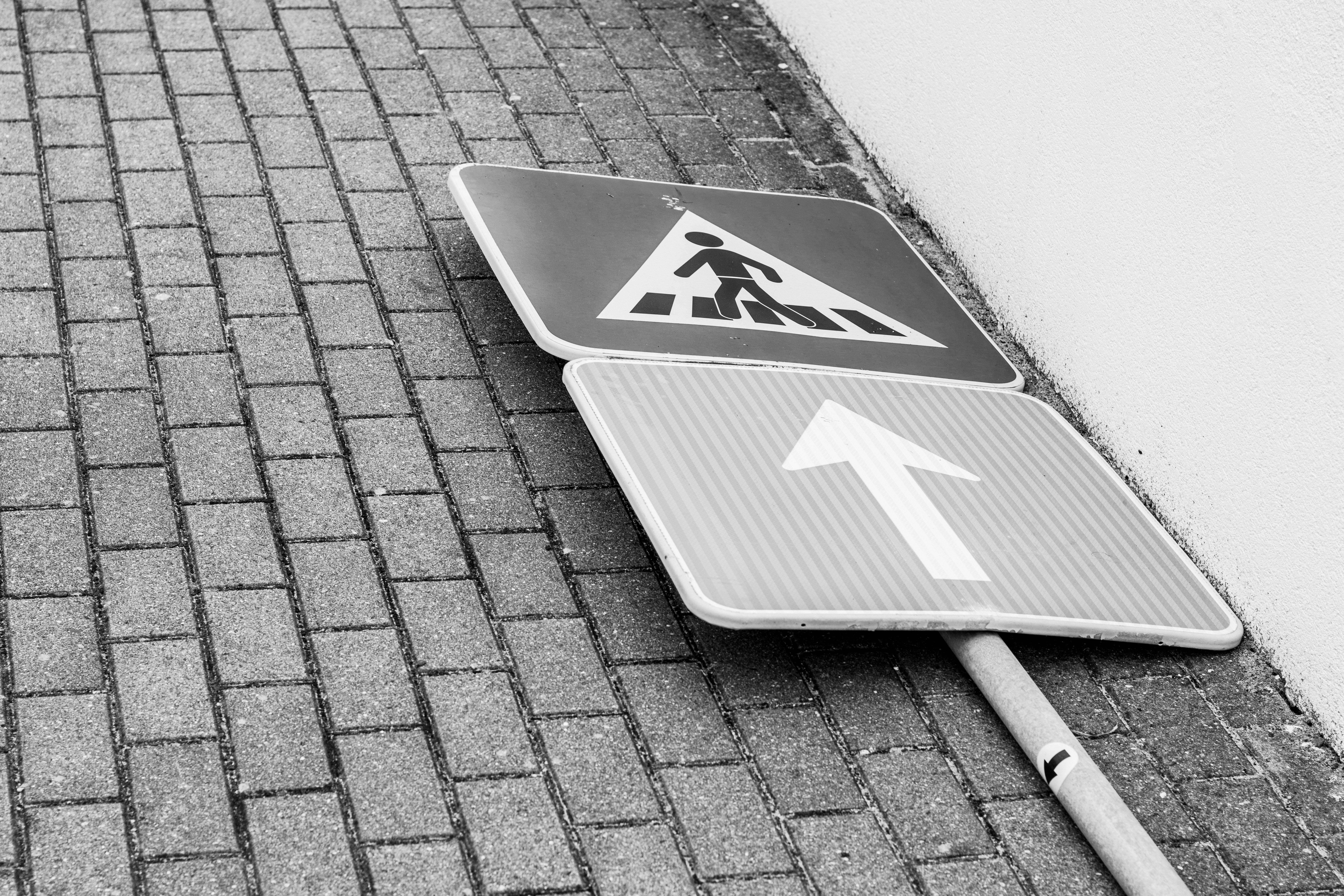 Fallen Street Sign on Brick Pavement · Free Stock Photo