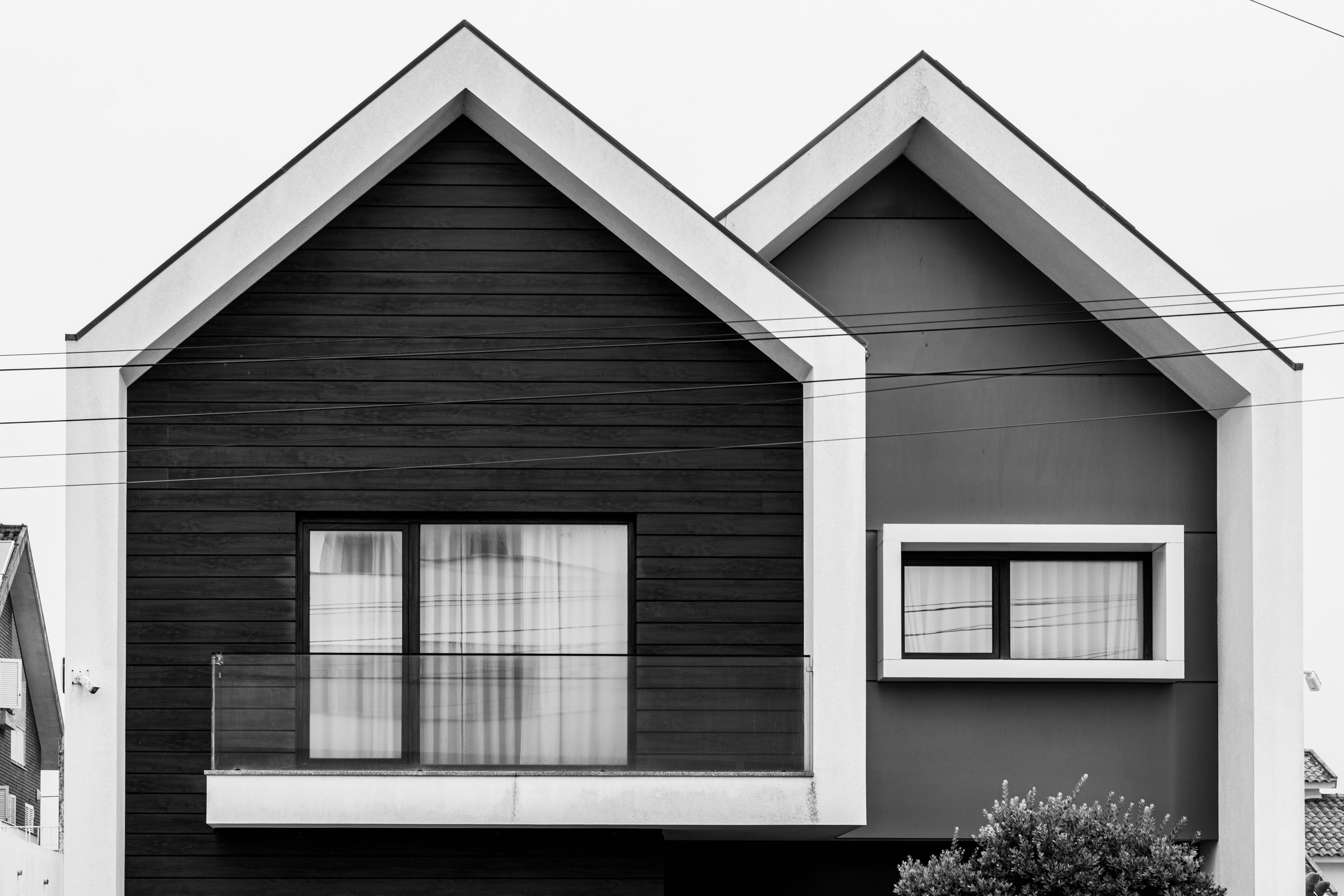 Modern home with a flat roof section showing membrane roofing