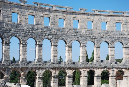 Free Stunning view of the ancient Roman amphitheater in Pula, Croatia against a clear blue sky. Stock Photo