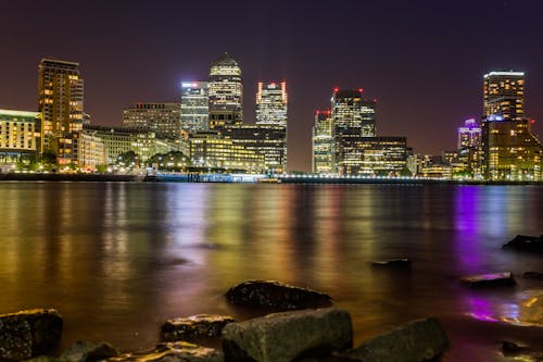 Body of Water Across City Buildings during Night