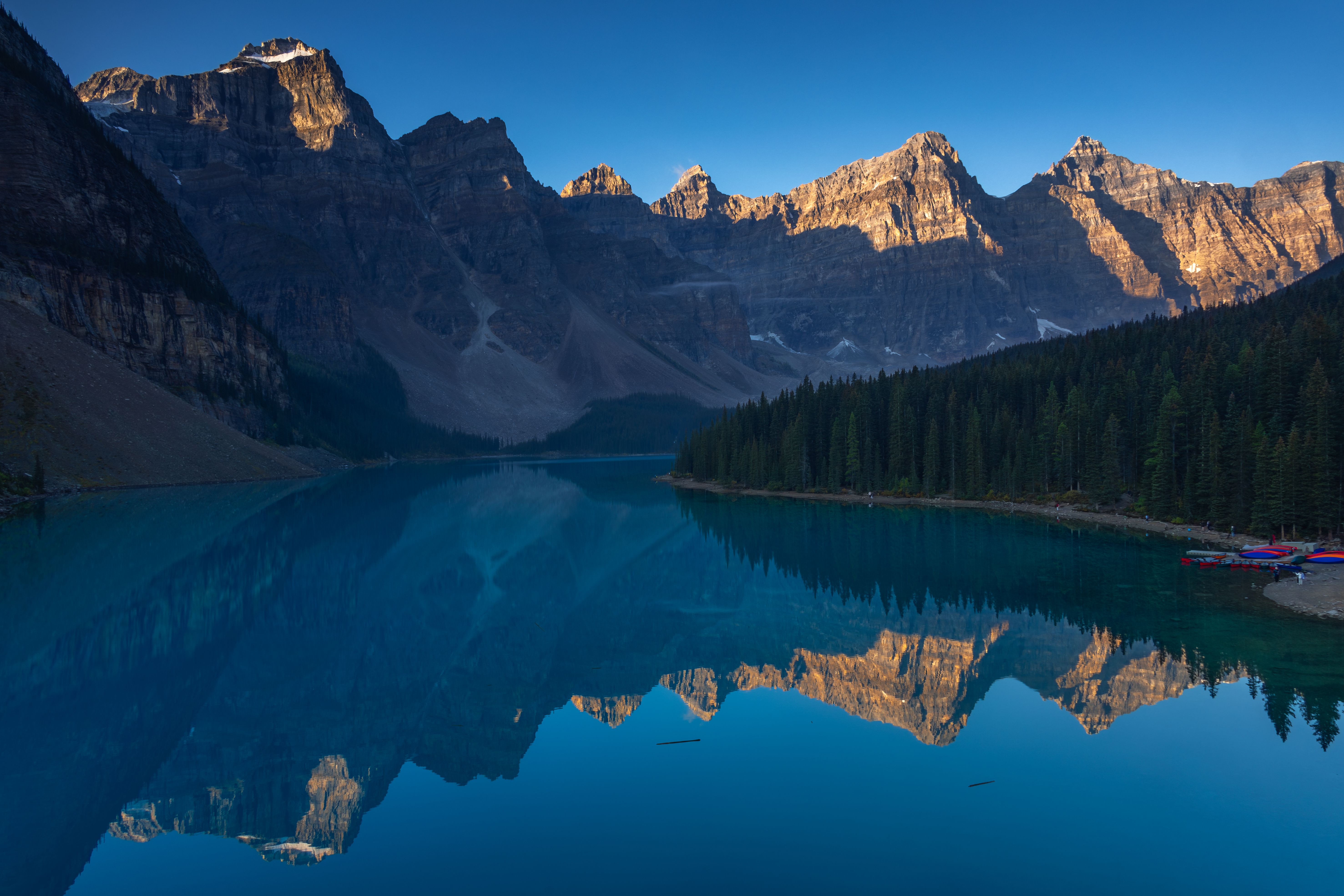 Experience the breathtaking view of Moraine Lake and the Canadian Rockies at sunrise in Banff National Park.