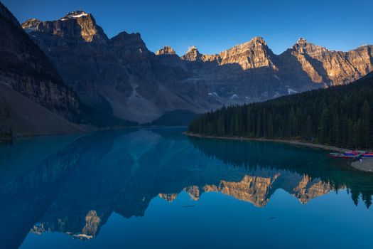 Experience the breathtaking view of Moraine Lake and the Canadian Rockies at sunrise in Banff National Park.