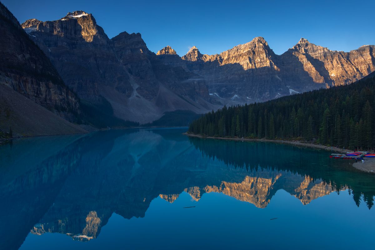 Experience the breathtaking view of Moraine Lake and the Canadian Rockies at sunrise in Banff National Park.