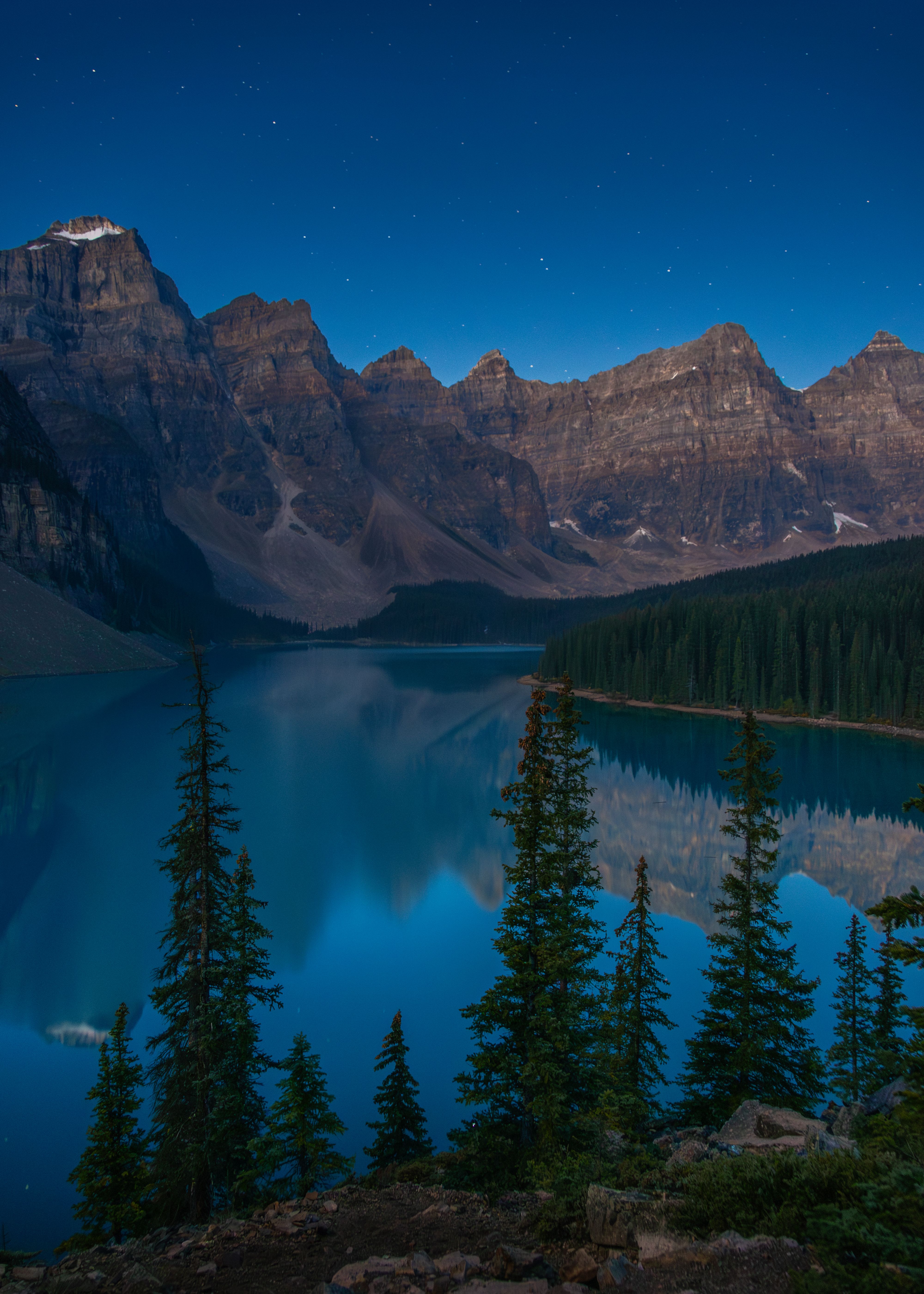 Explore the captivating beauty of Moraine Lake at twilight in Banff National Park, Alberta.